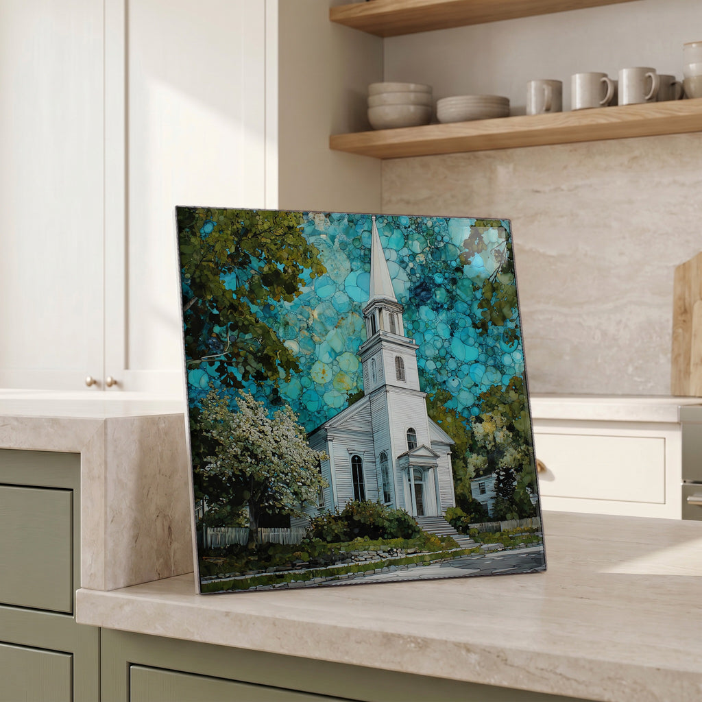 Beside the kettle, propped on the counter.