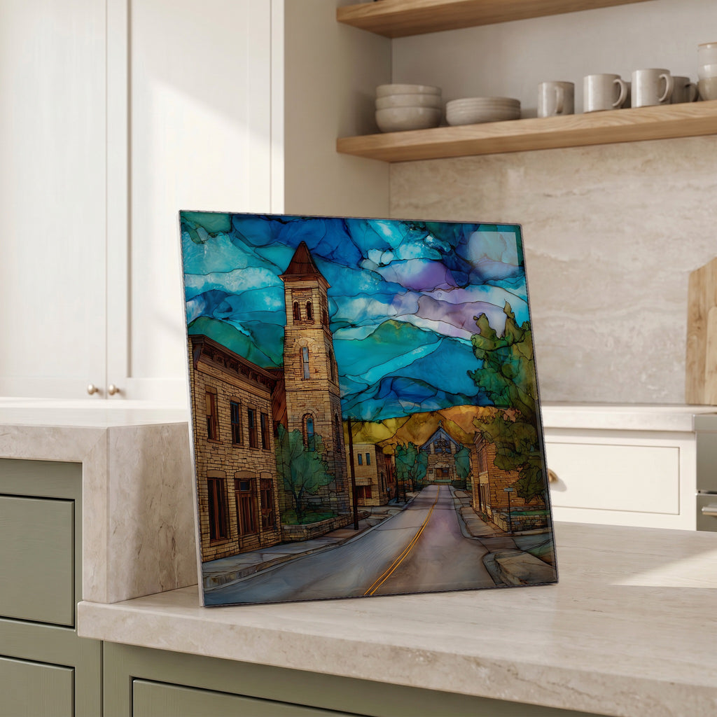 Beside the kettle, propped on the counter.