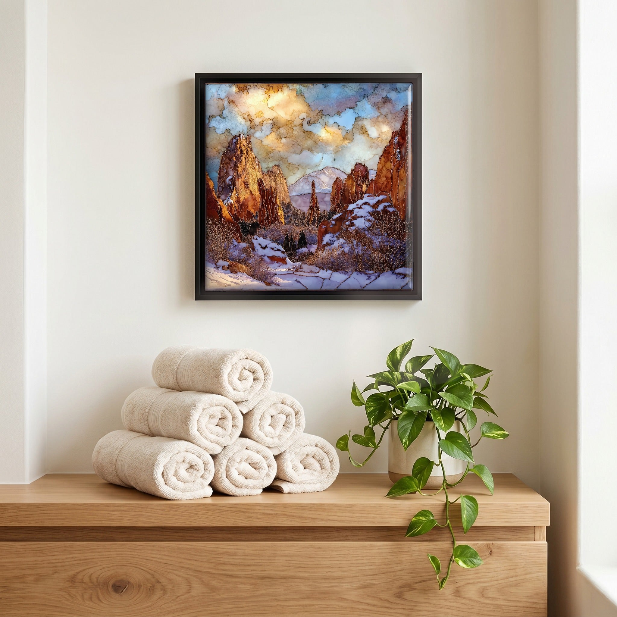 Above the linens, in a slim black surround.