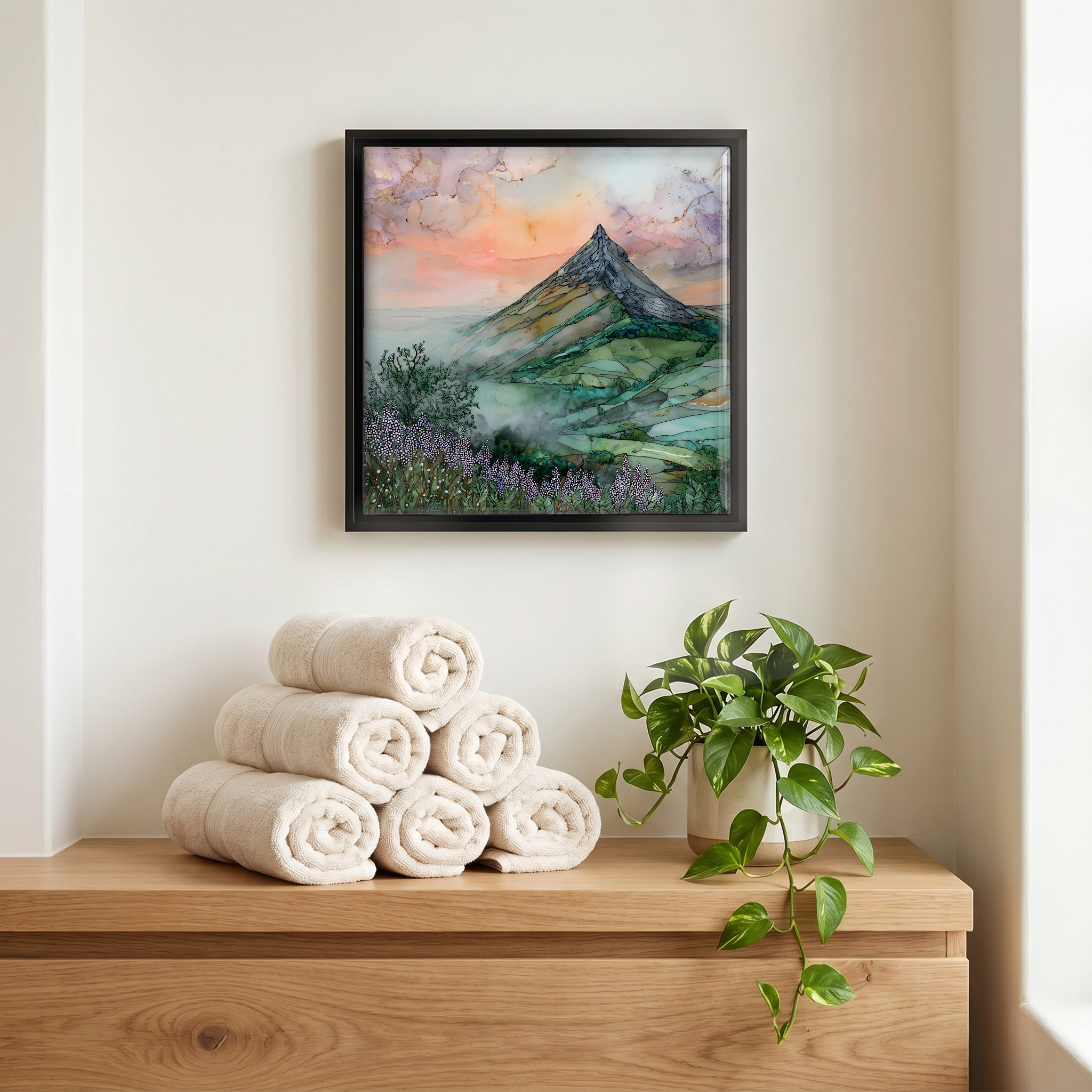 Above the linens, in a slim black surround.