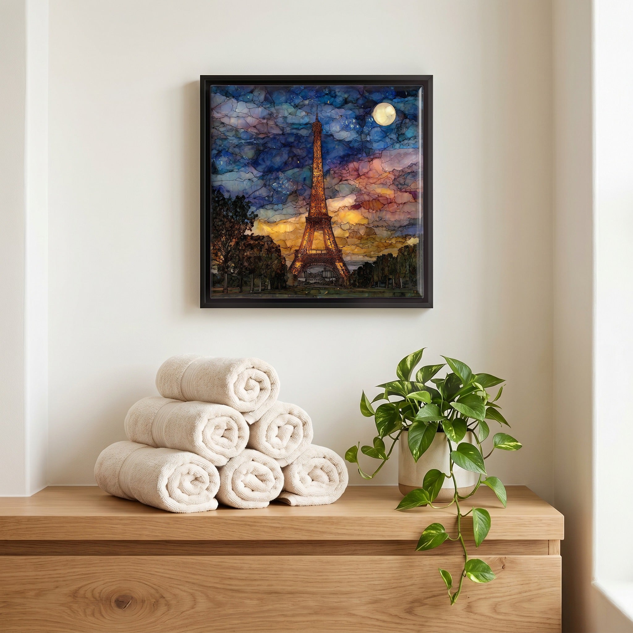 Above the linens, in a slim black surround.