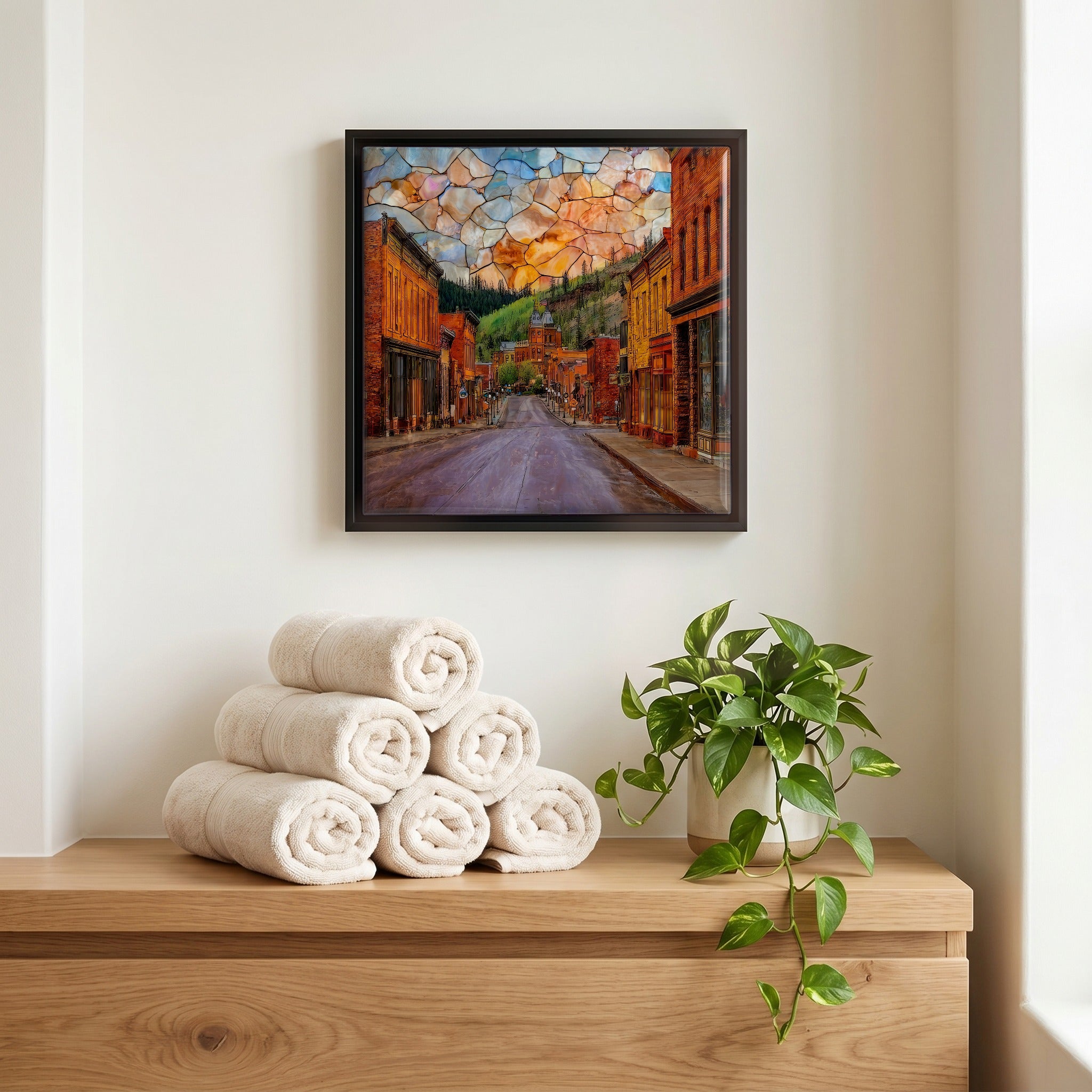 Above the linens, in a slim black surround.