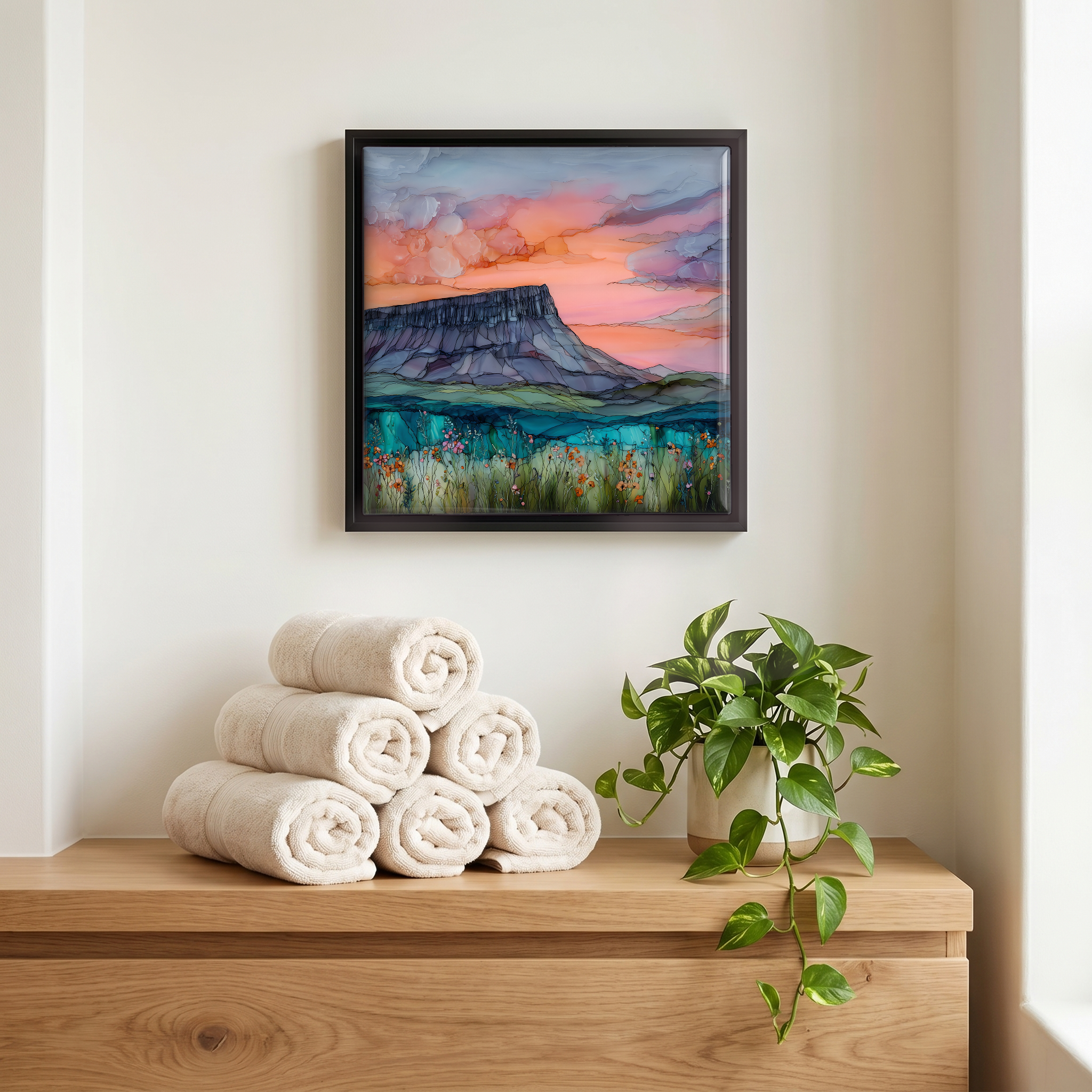 Above the linens, in a slim black surround.