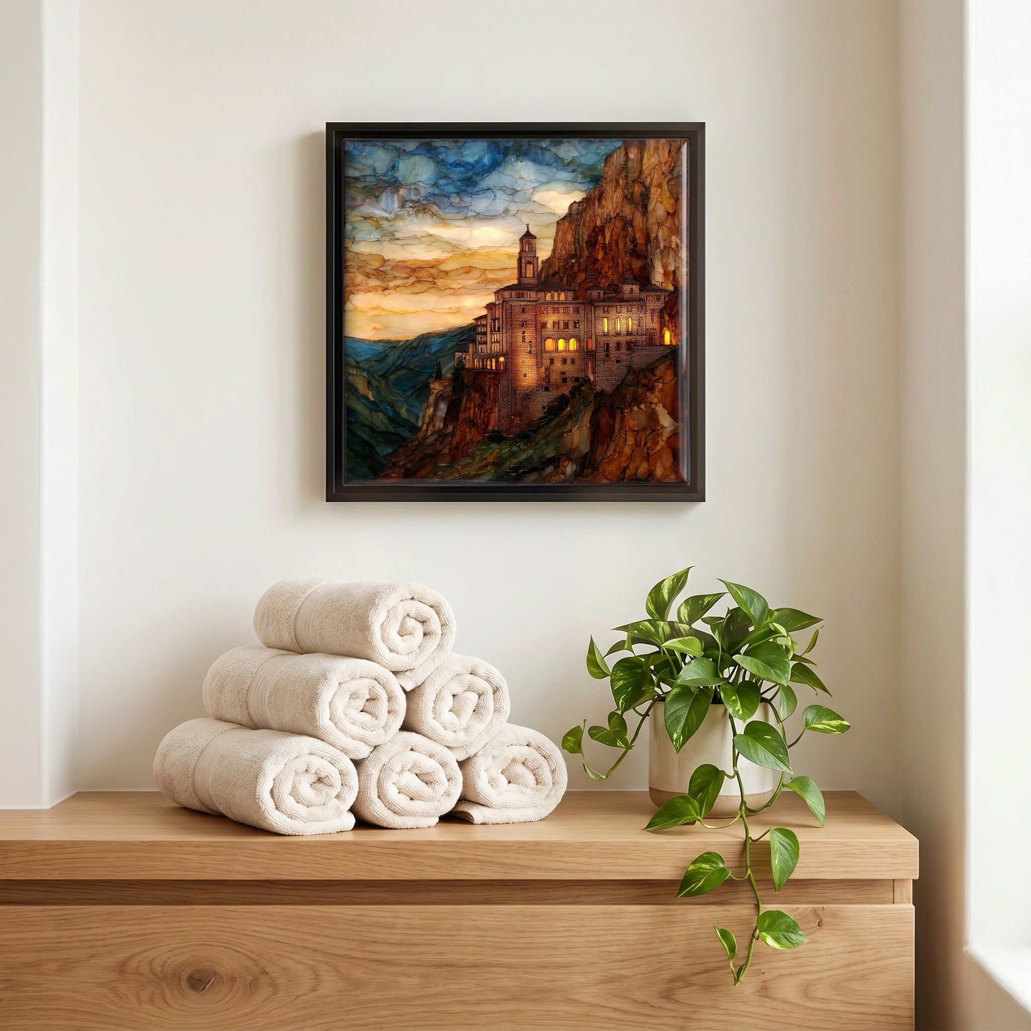 Above the linens, in a slim black surround.