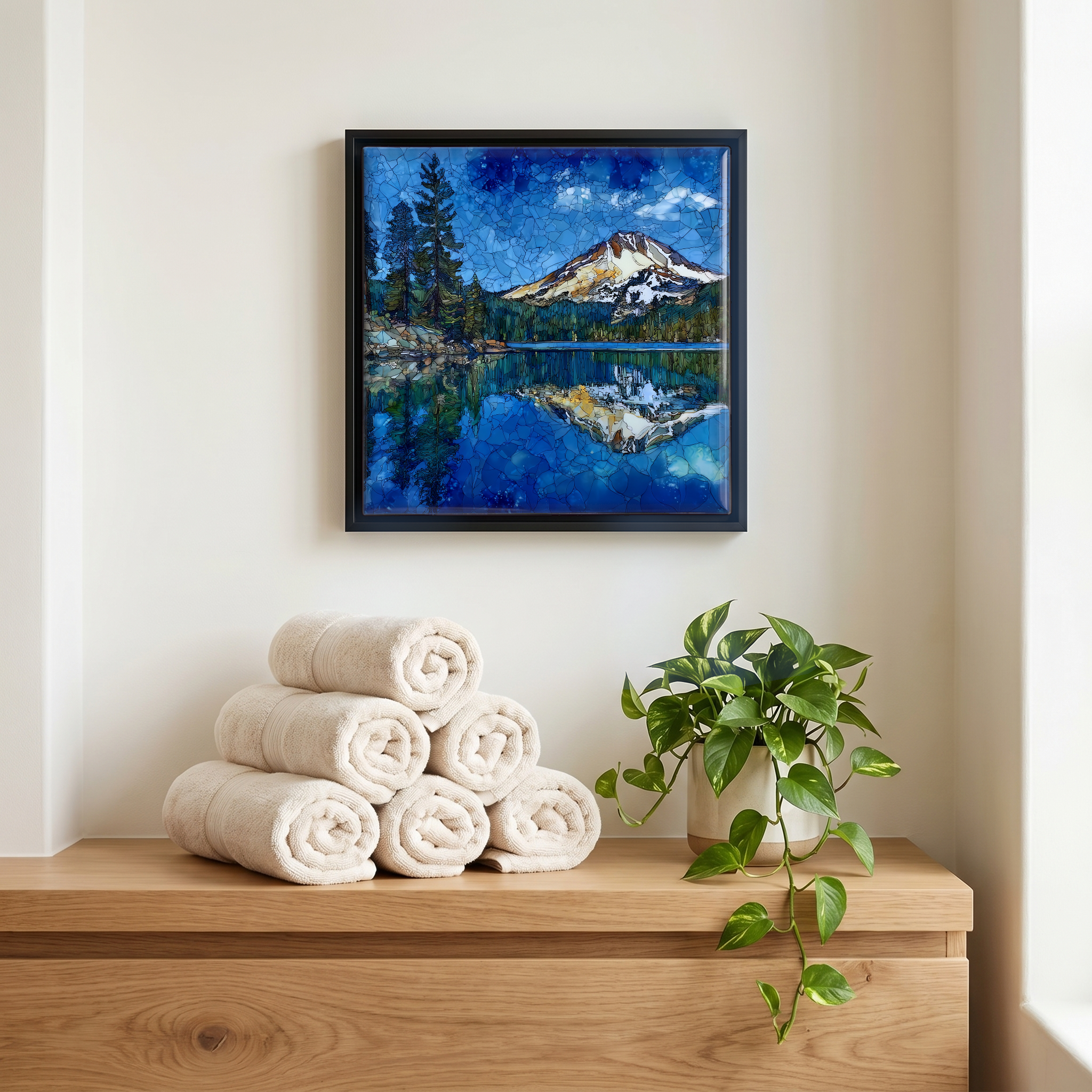 Above the linens, in a slim black surround.