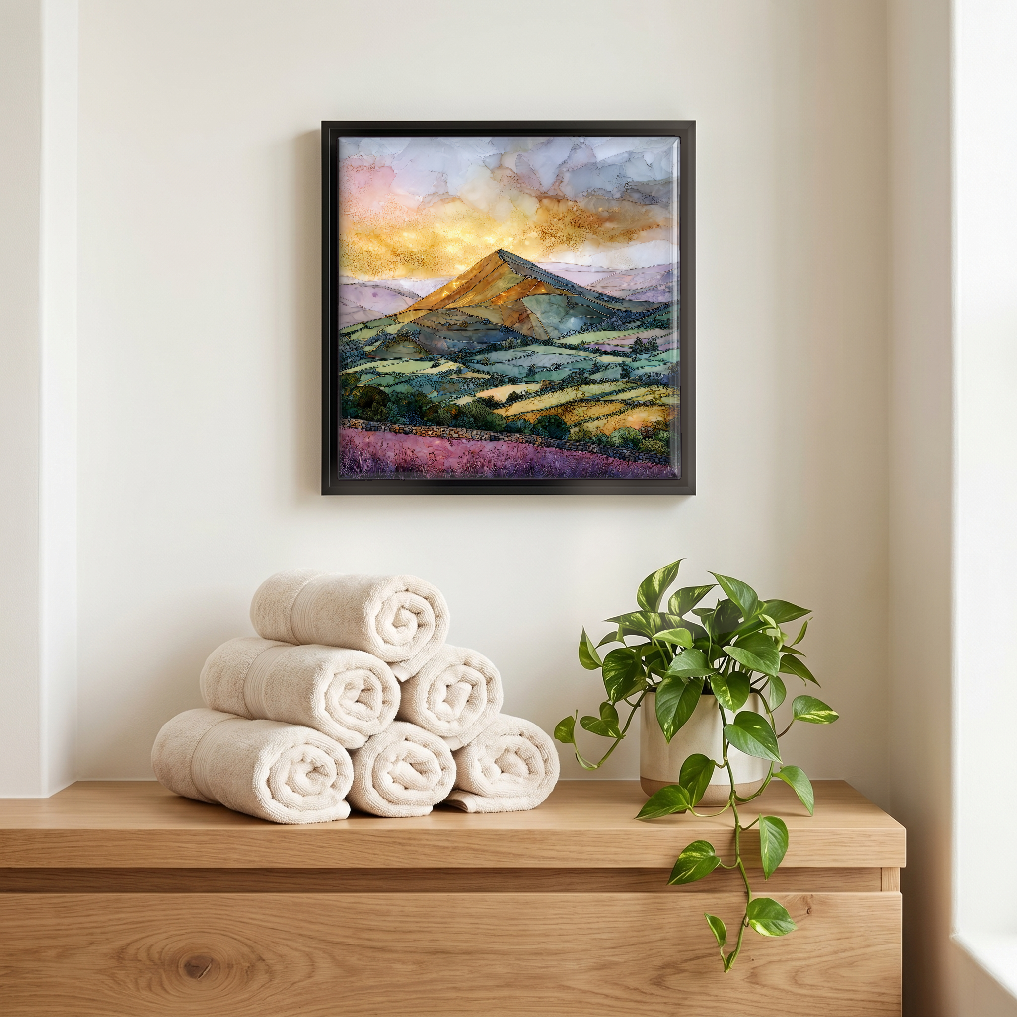 Above the linens, in a slim black surround.