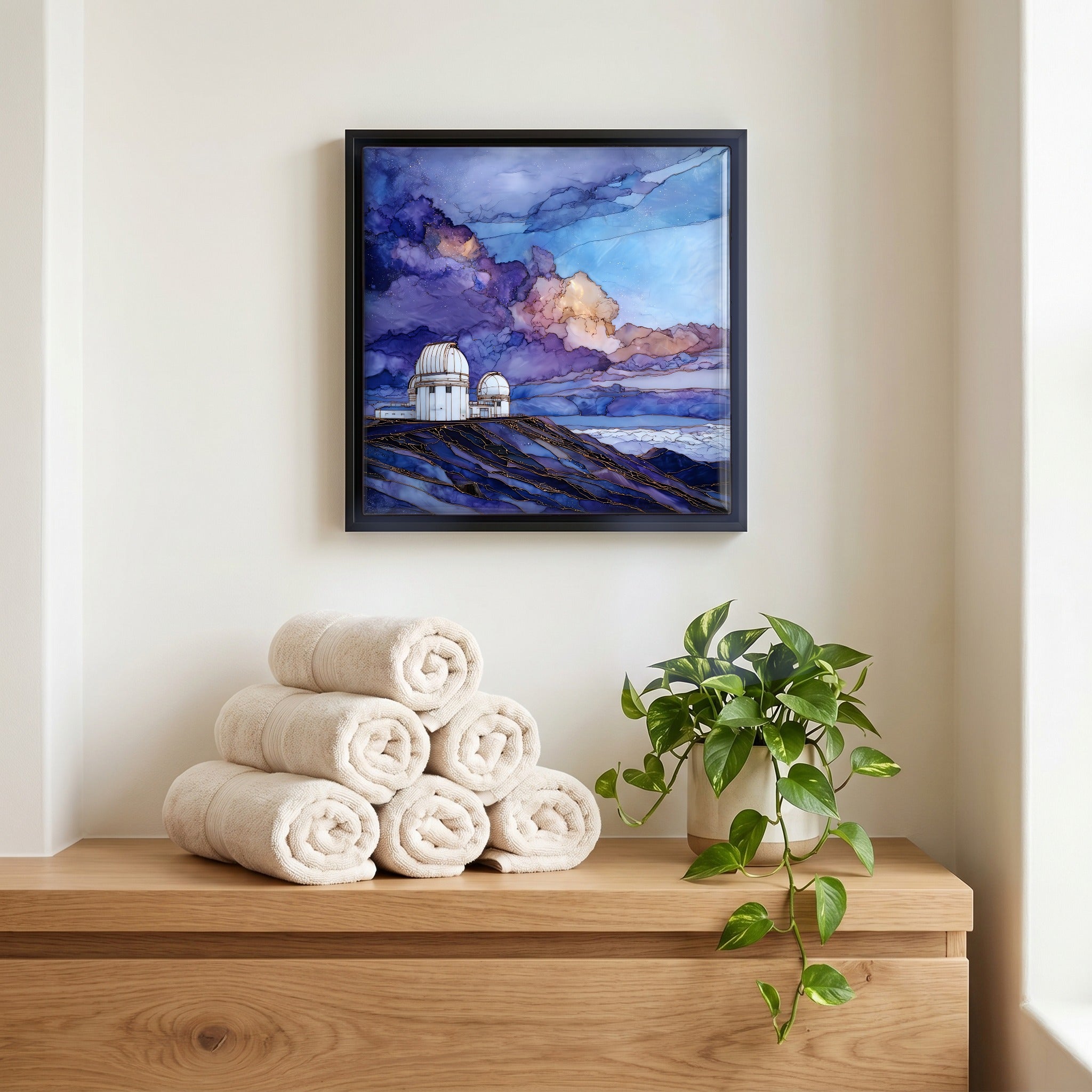 Above the linens, in a slim black surround.