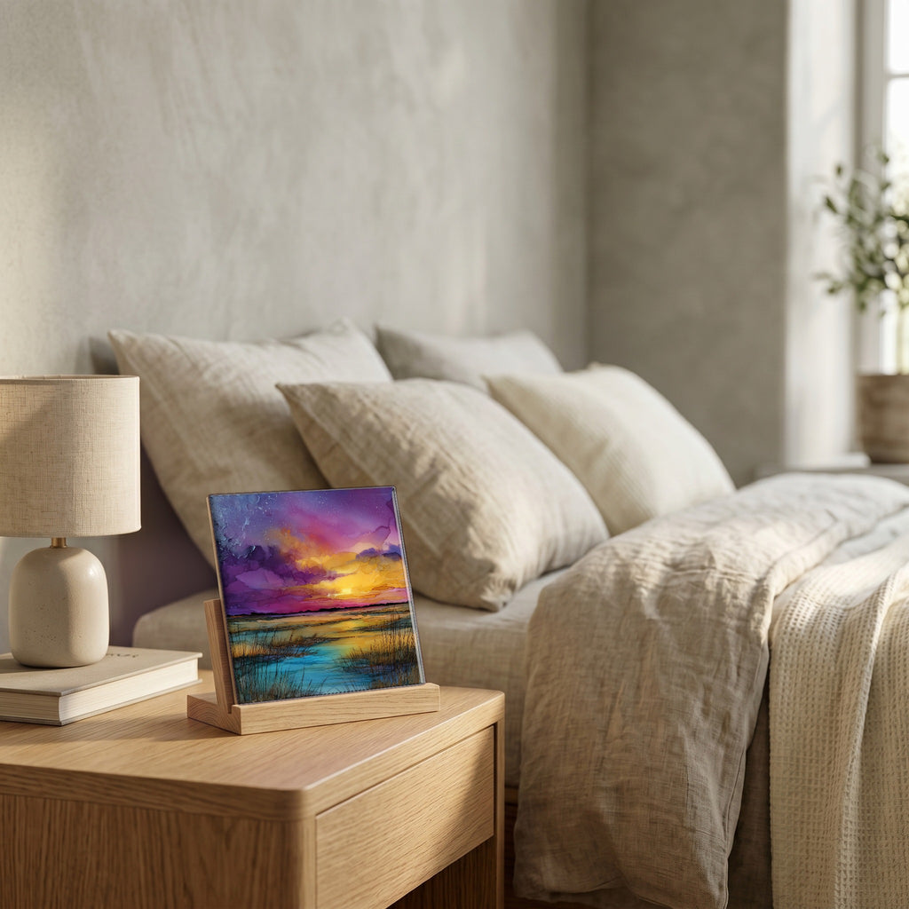 On the nightstand, on a light oak stand.
