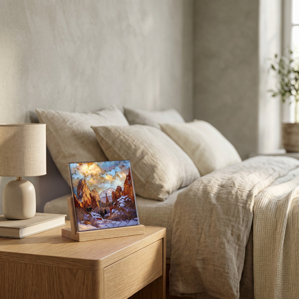 On the nightstand, on a light oak stand.