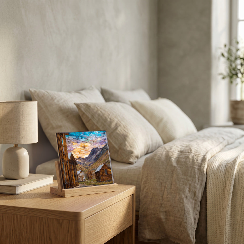 On the nightstand, on a light oak stand.