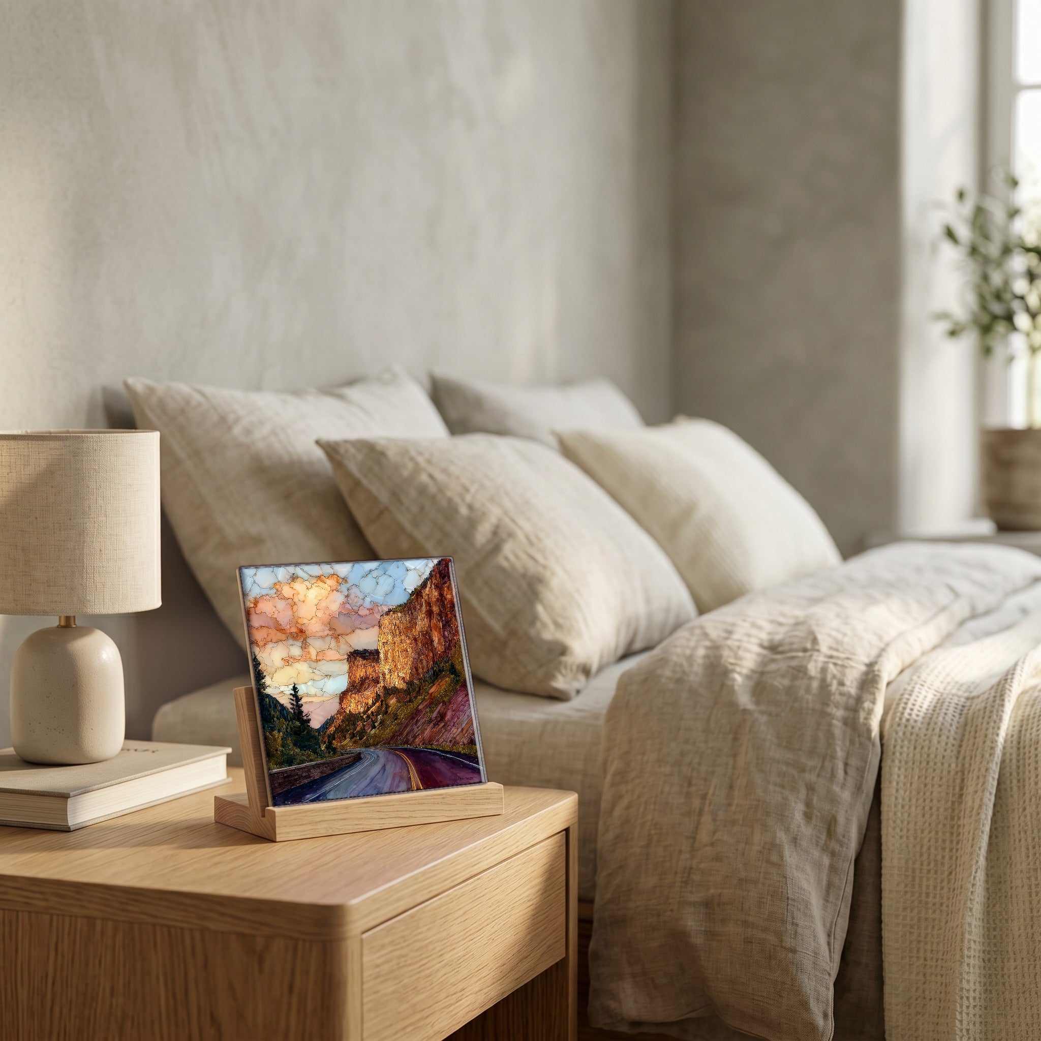 On the nightstand, on a light oak stand.