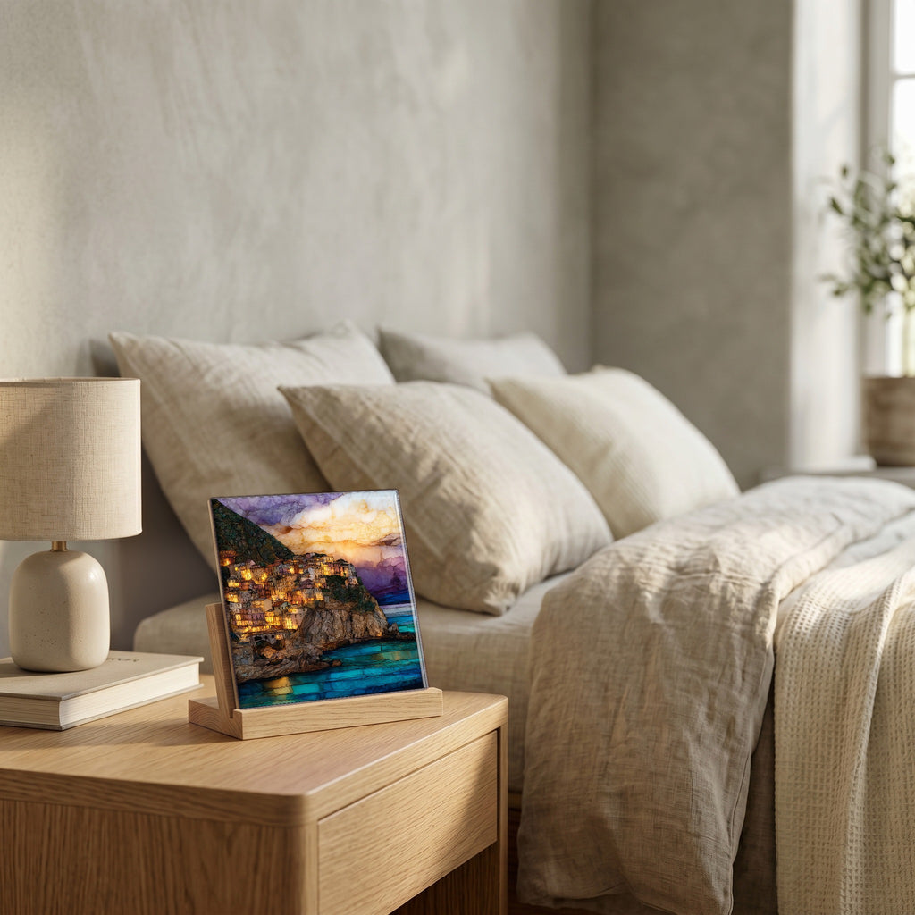 On the nightstand, on a light oak stand.
