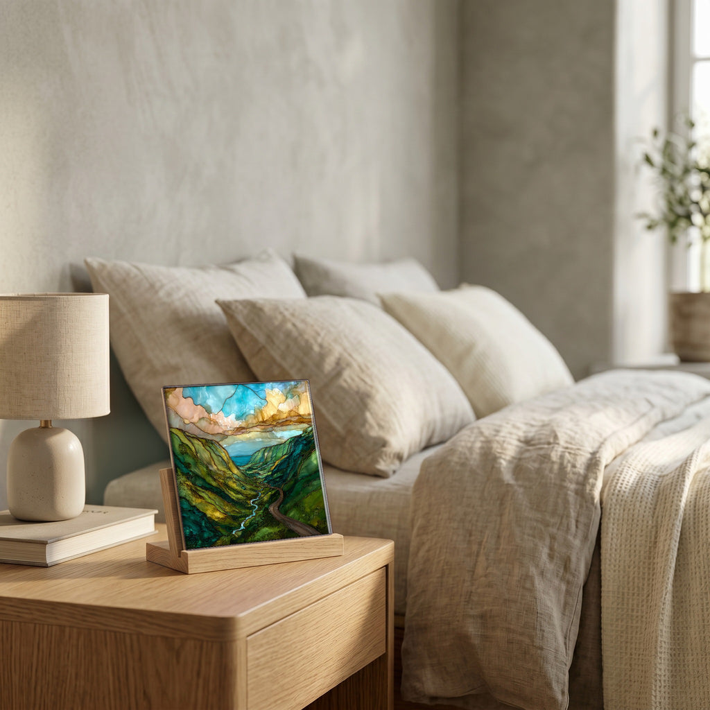 On the nightstand, on a light oak stand.