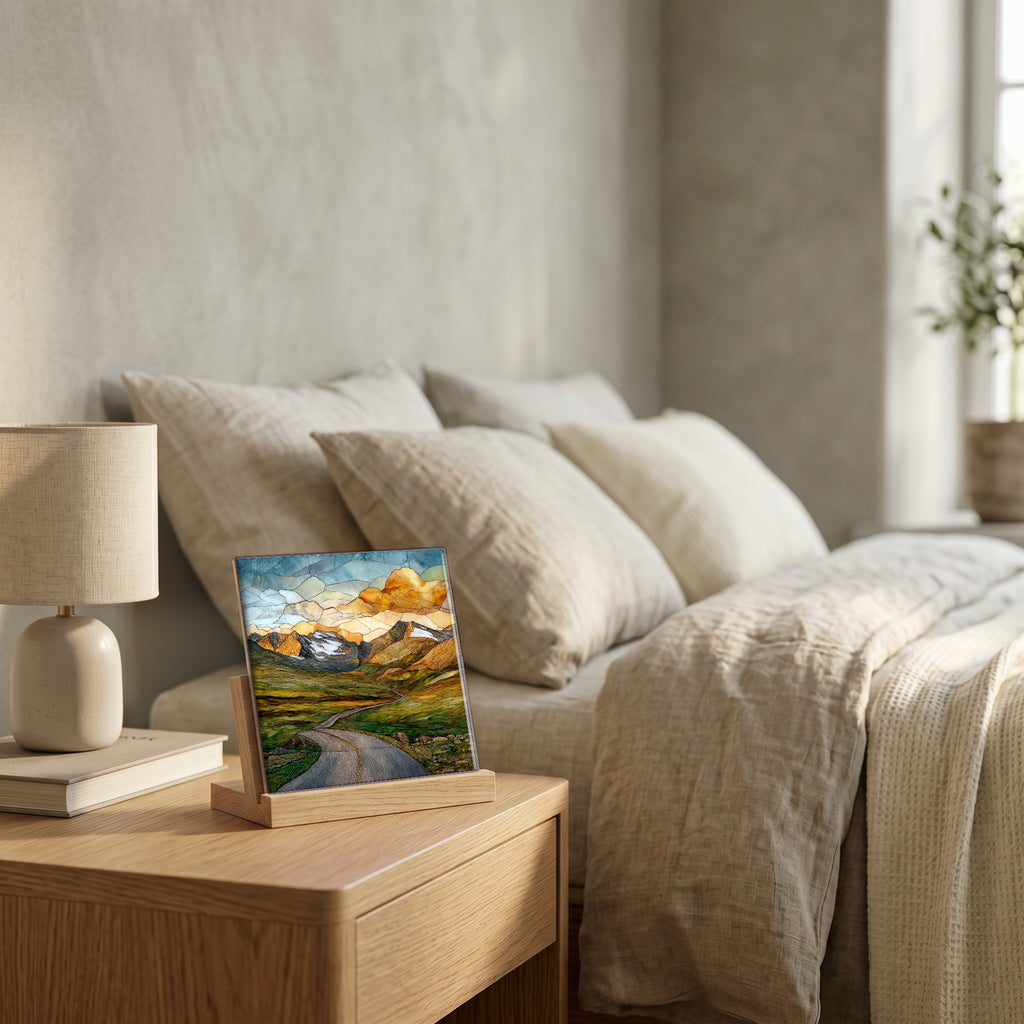 On the nightstand, on a light oak stand.