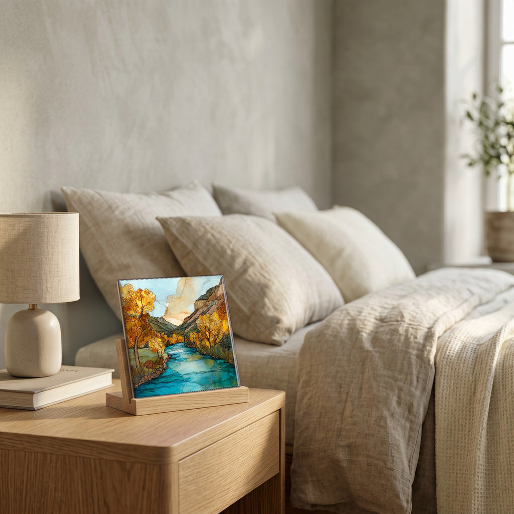 On the nightstand, on a light oak stand.