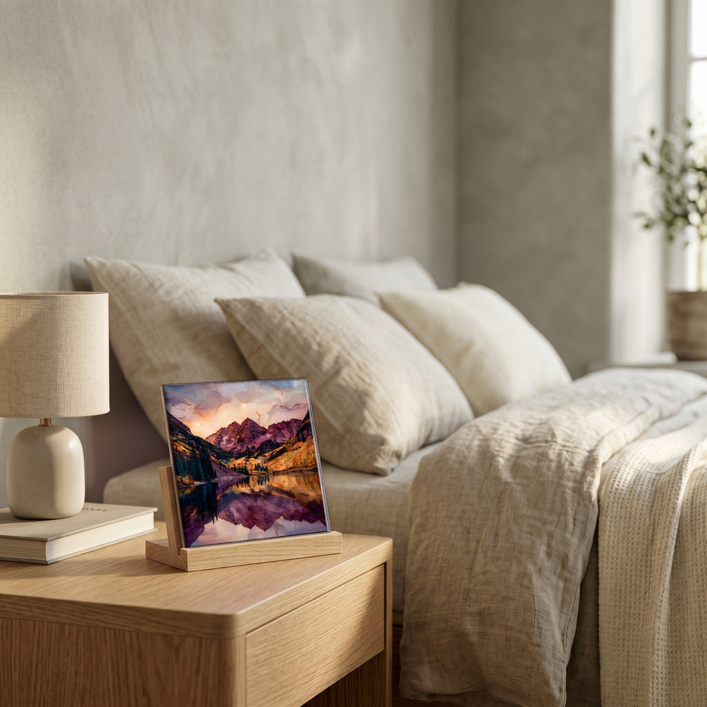 On the nightstand, on a light oak stand.