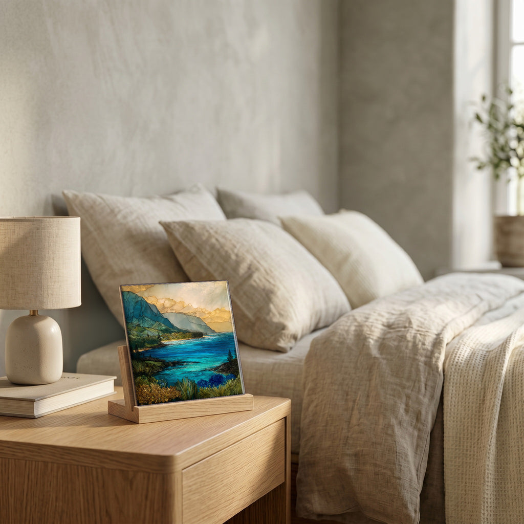 On the nightstand, on a light oak stand.