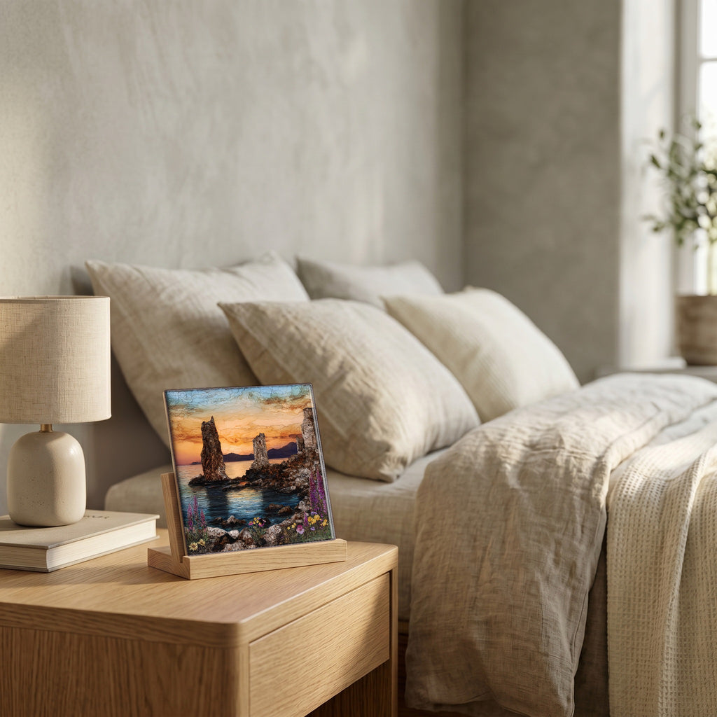 On the nightstand, on a light oak stand.