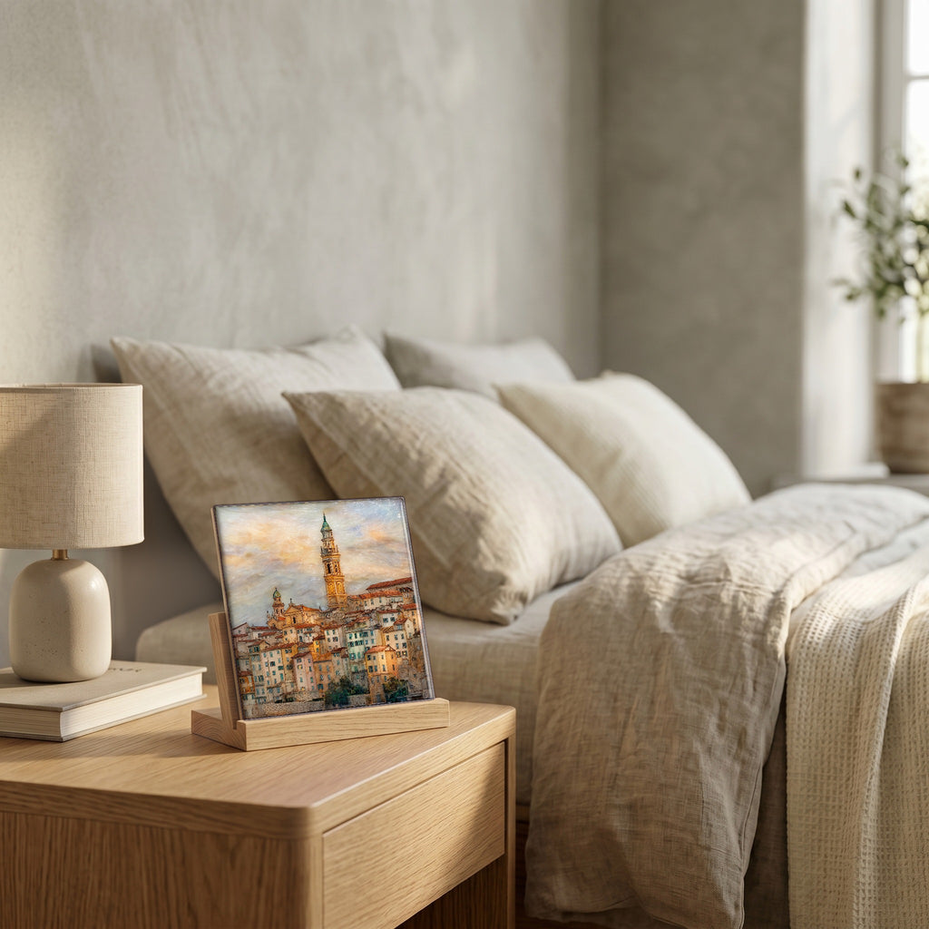 On the nightstand, on a light oak stand.