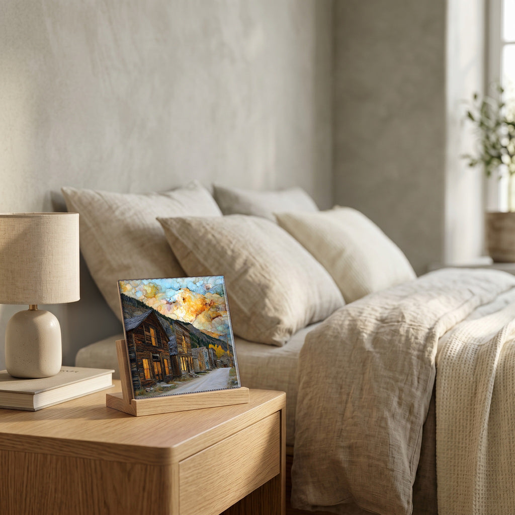 On the nightstand, on a light oak stand.