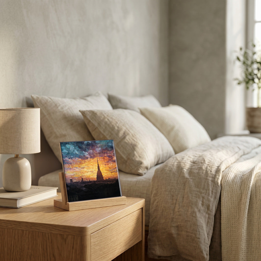 On the nightstand, on a light oak stand.