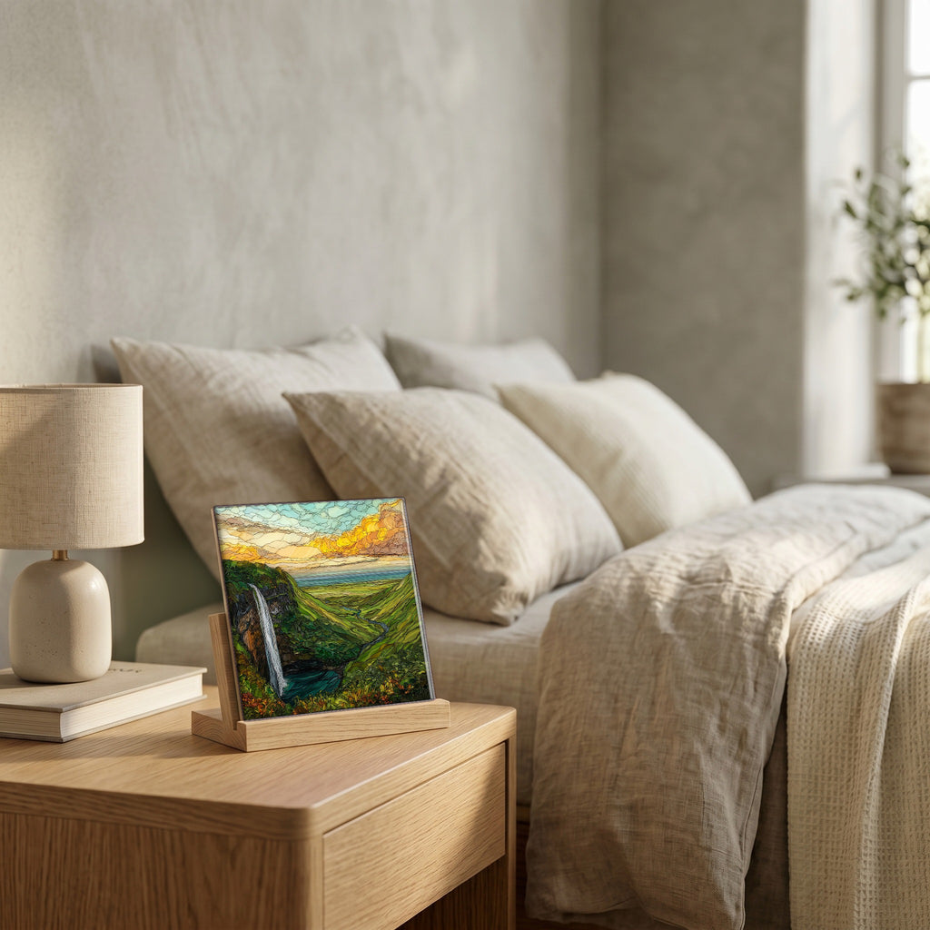 On the nightstand, on a light oak stand.