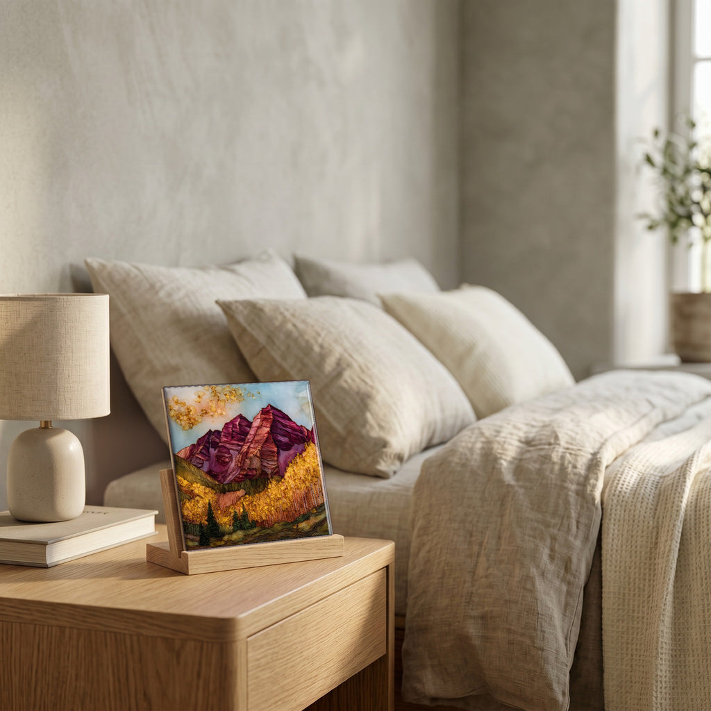 On the nightstand, on a light oak stand.