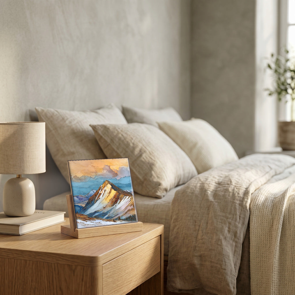 On the nightstand, on a light oak stand.
