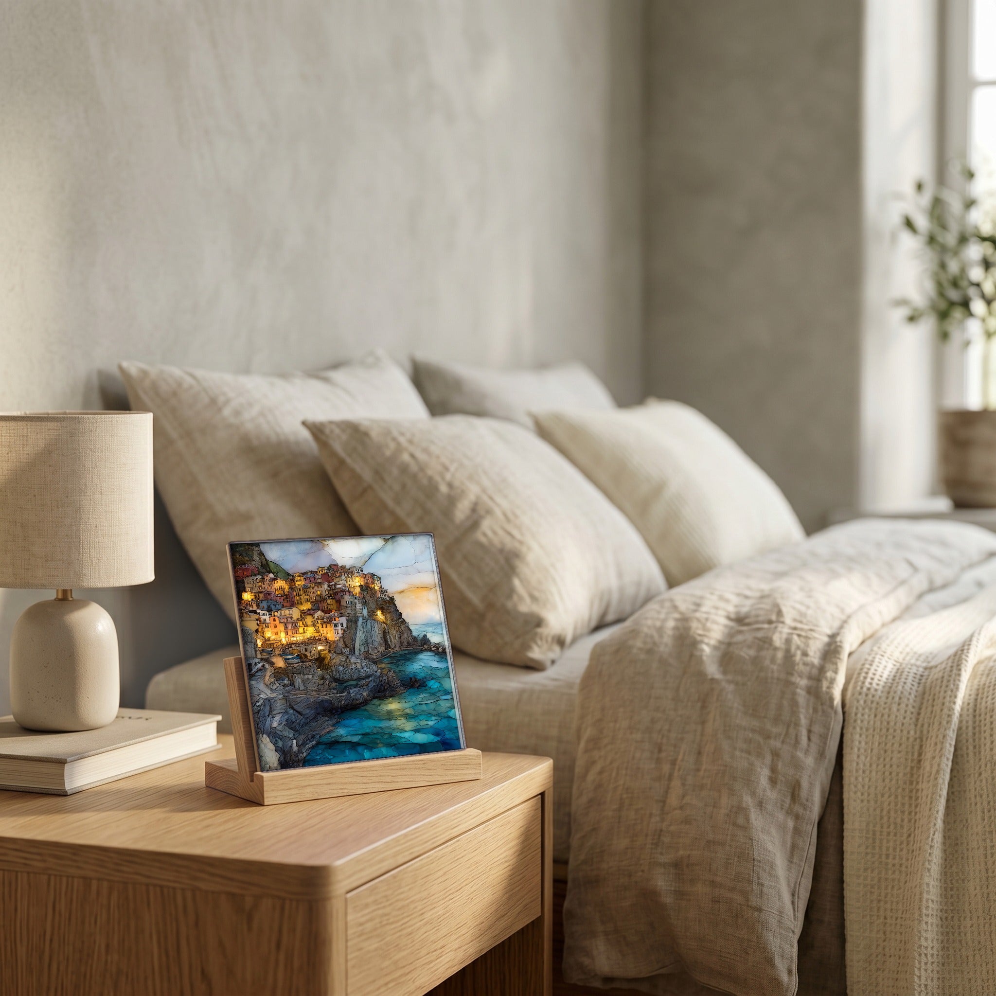 On the nightstand, on a light oak stand.