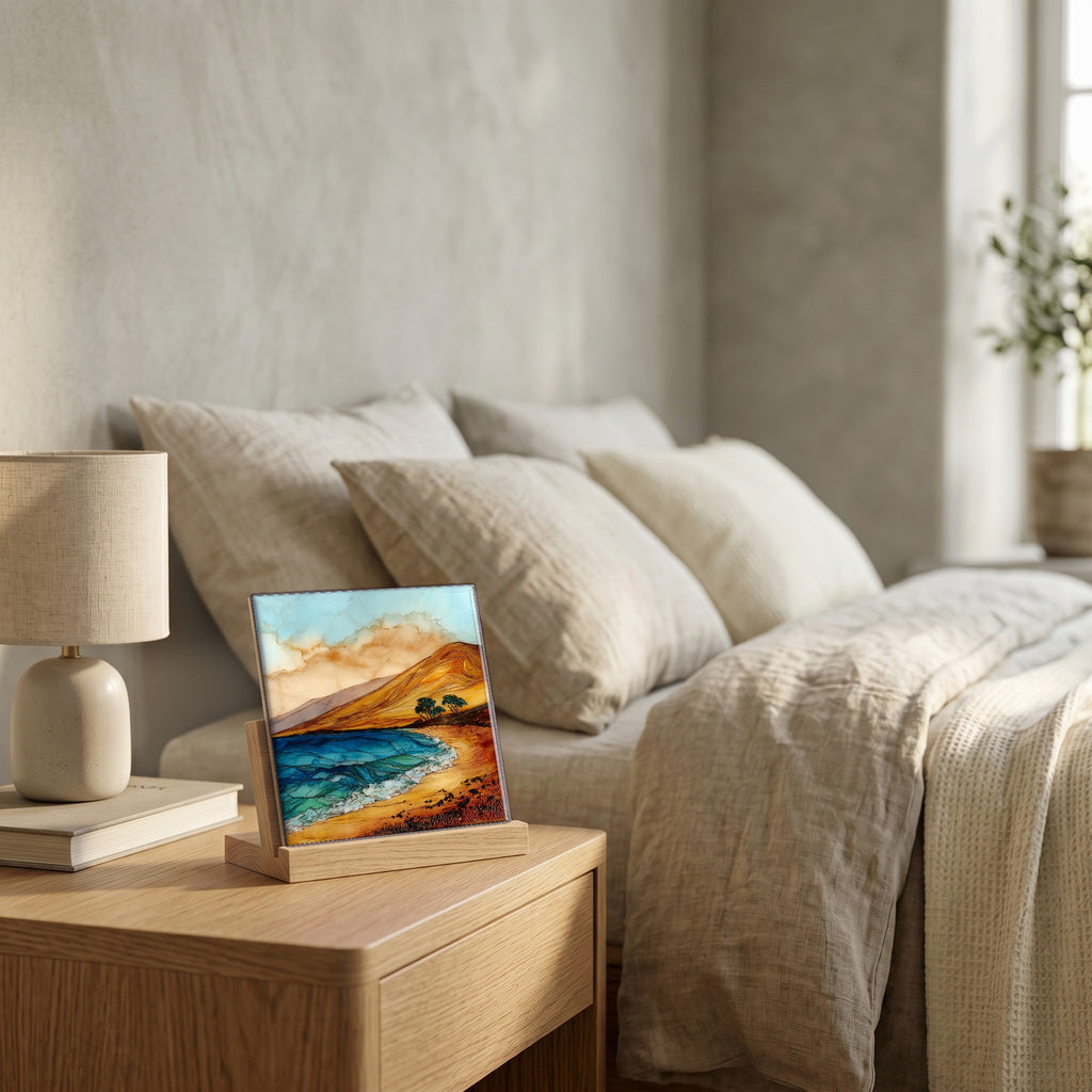 On the nightstand, on a light oak stand.