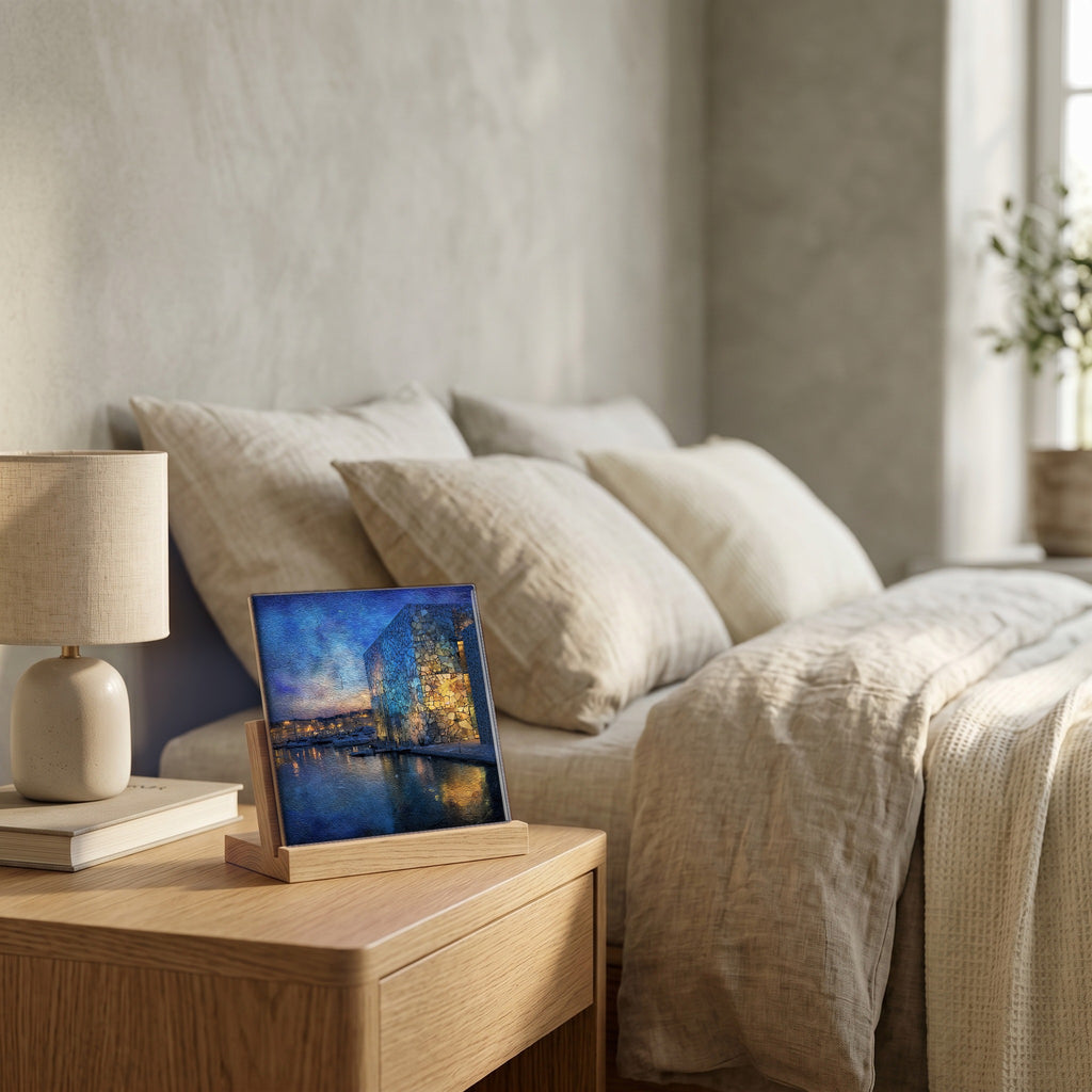 On the nightstand, on a light oak stand.