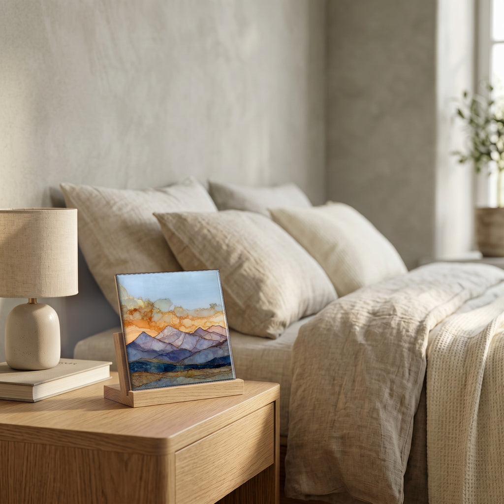 On the nightstand, on a light oak stand.