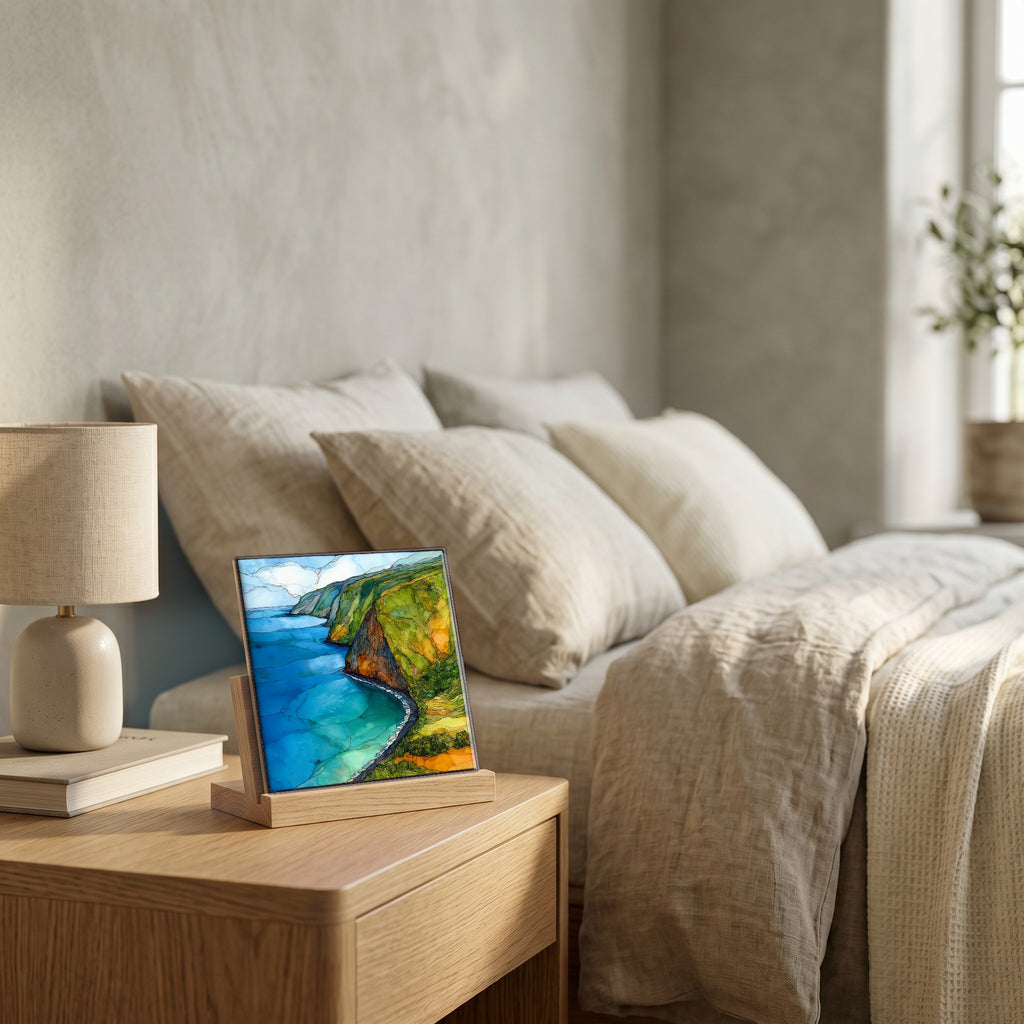 On the nightstand, on a light oak stand.
