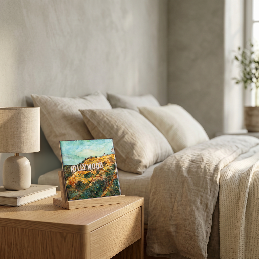 On the nightstand, on a light oak stand.