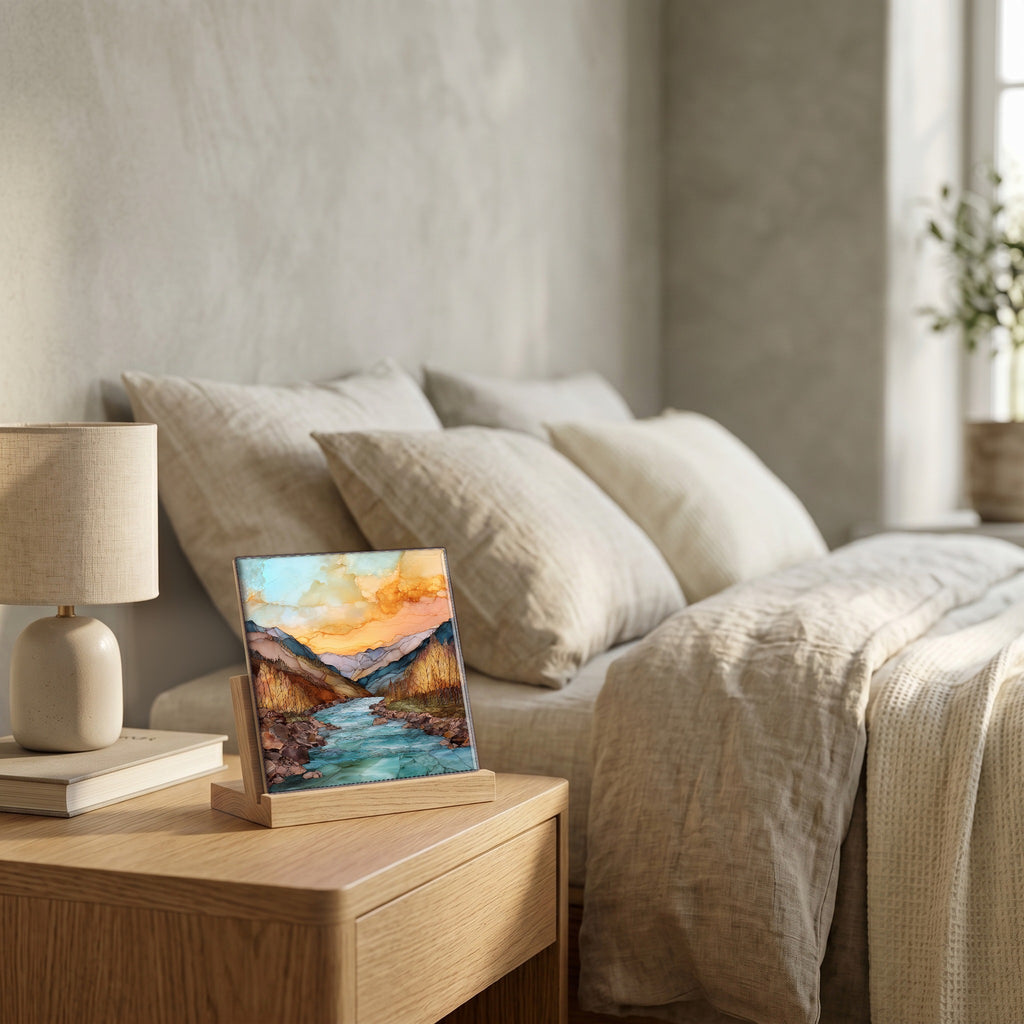 On the nightstand, on a light oak stand.