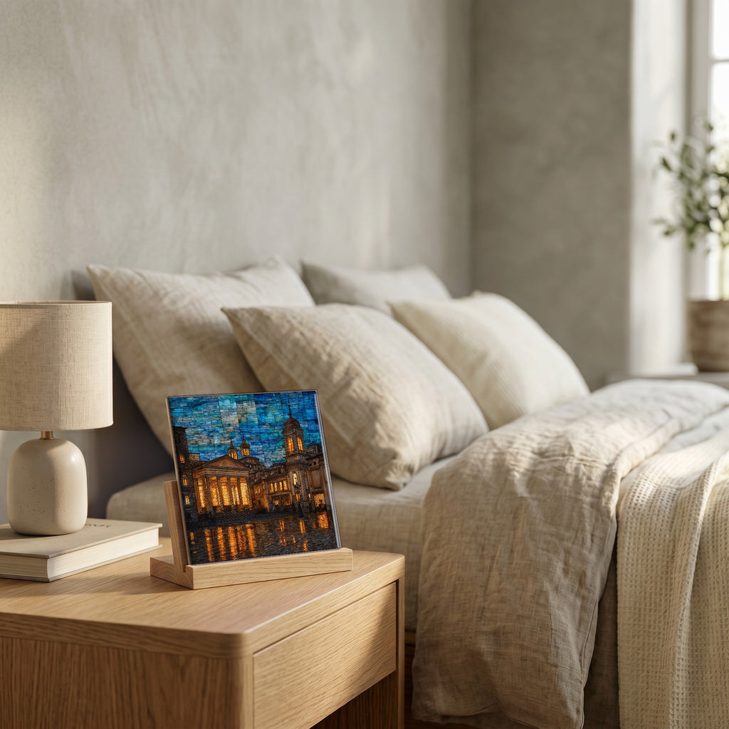 On the nightstand, on a light oak stand.