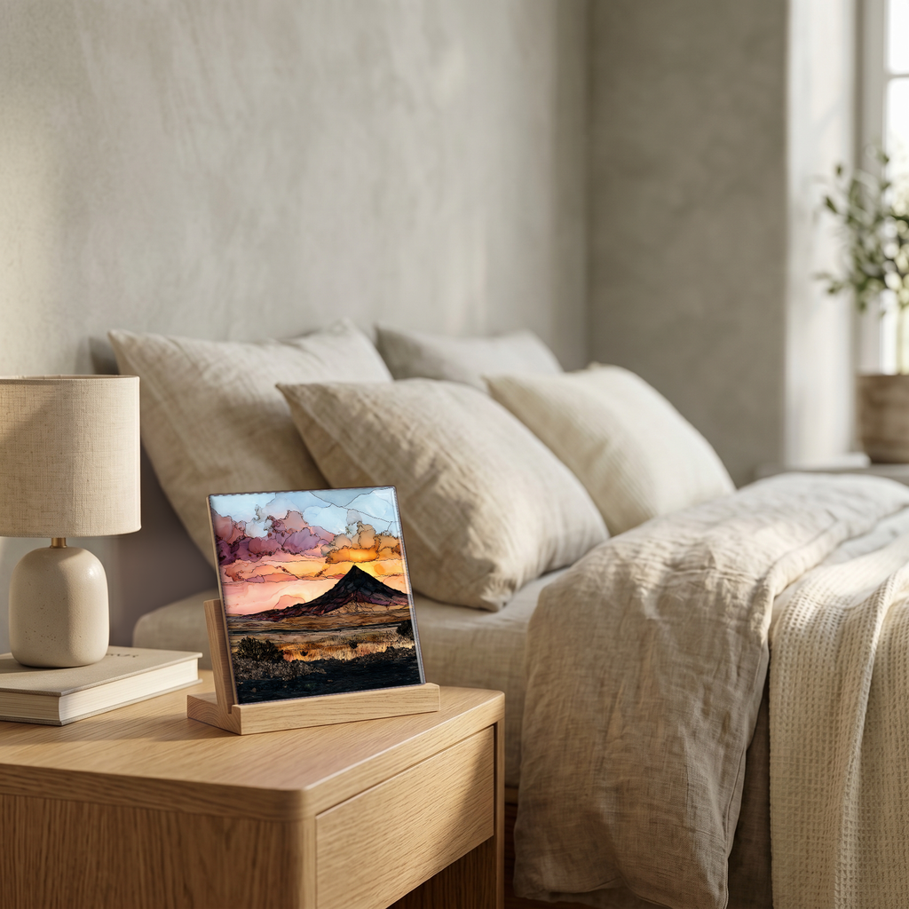 On the nightstand, on a light oak stand.