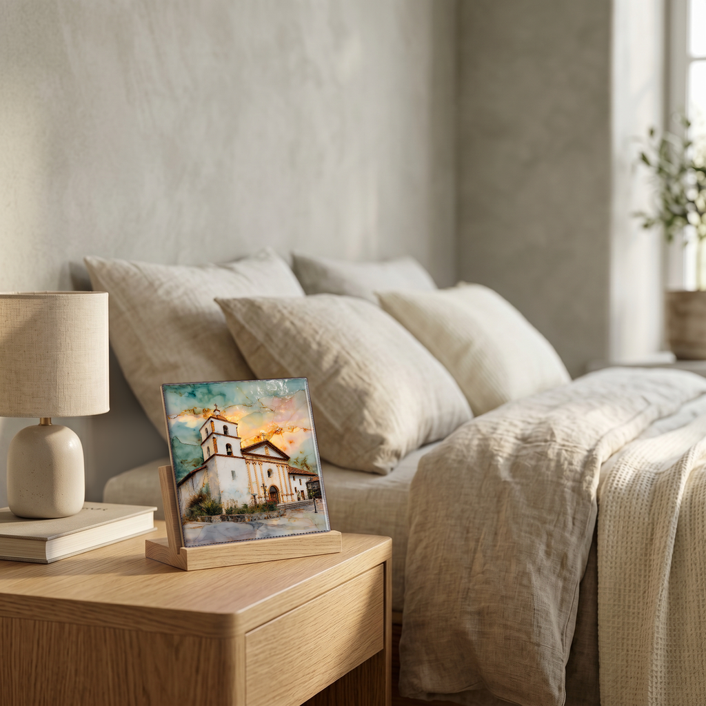 On the nightstand, on a light oak stand.