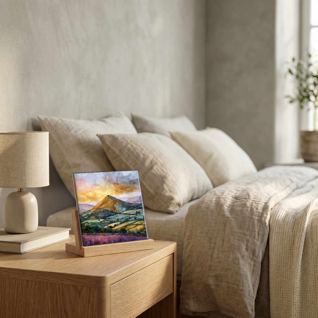 On the nightstand, on a light oak stand.