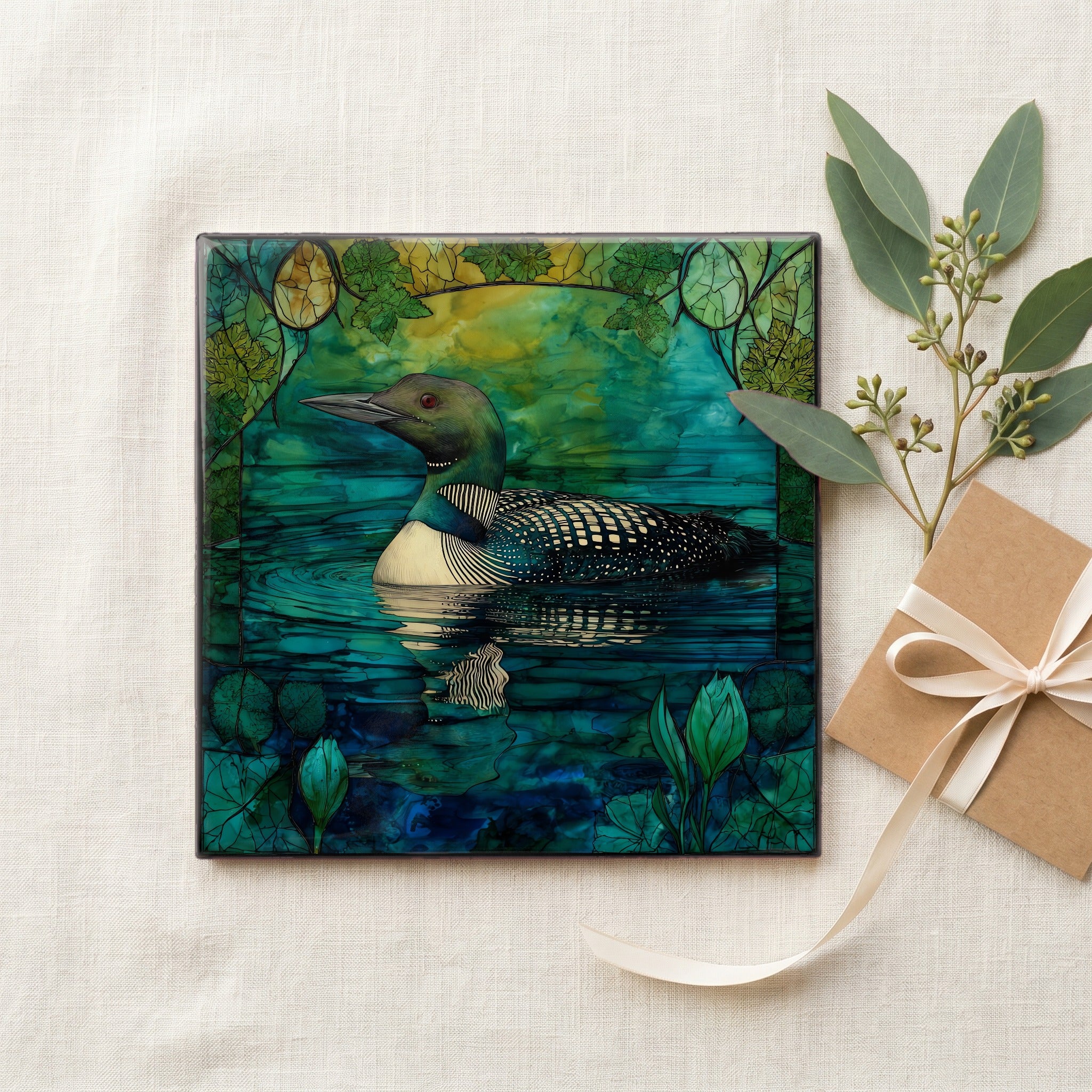 a common loon swimming on a — gifting